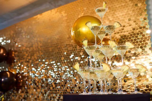 金色の壁の前にあるシャンパンタワー